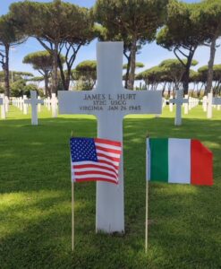 Photo: Headstone labeled "James L. Hurt, STZC USCG, Virginia, Jan 26 1945" with small flags of the U.S.A. and Italy.