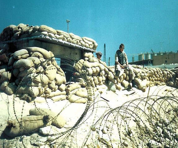 Photo: A rocky bunker with stone walls and razor wire.