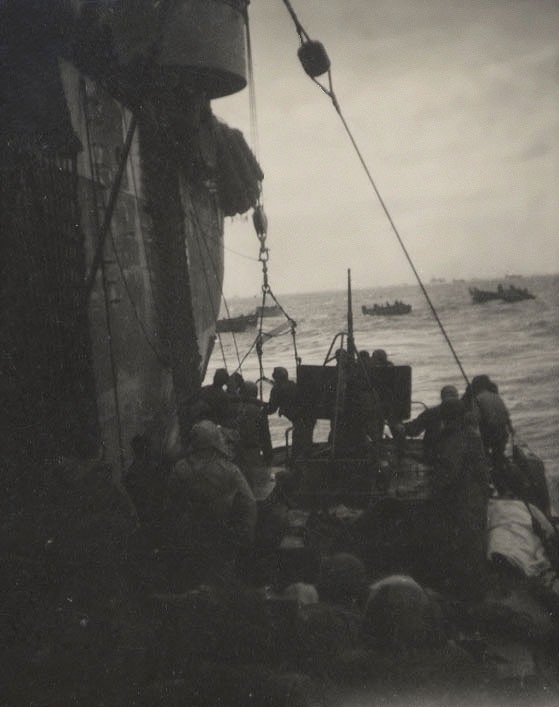 Photo: An 83-footer tied alongside a Navy attack transport to disembark a load of survivors.