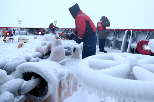 Photo: Crew works to remove heavy ice from the deck of Polar Star.