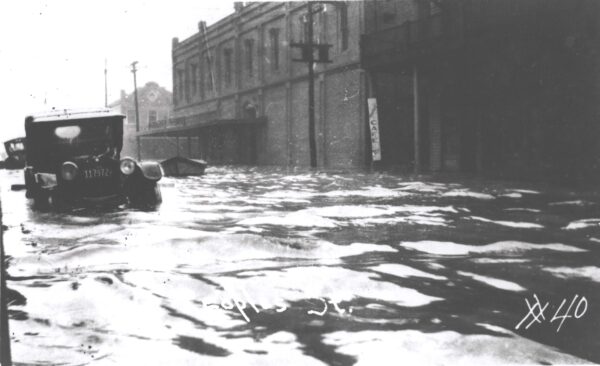 Photo: City streets covered in water and partially submerged cars.