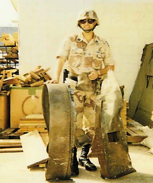 Photo: PSU member poses with large portions of a SCUD missile.