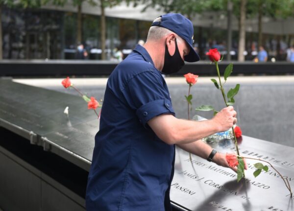 Photo: ADM Poulin leaves a flower at Jeffrey Palazzo’s name at the 9/11 Memorial.