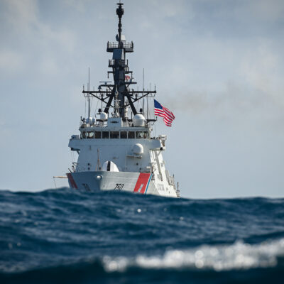 Photo: U.S. Coast Guard Cutter Bertholf with waves in foreground.