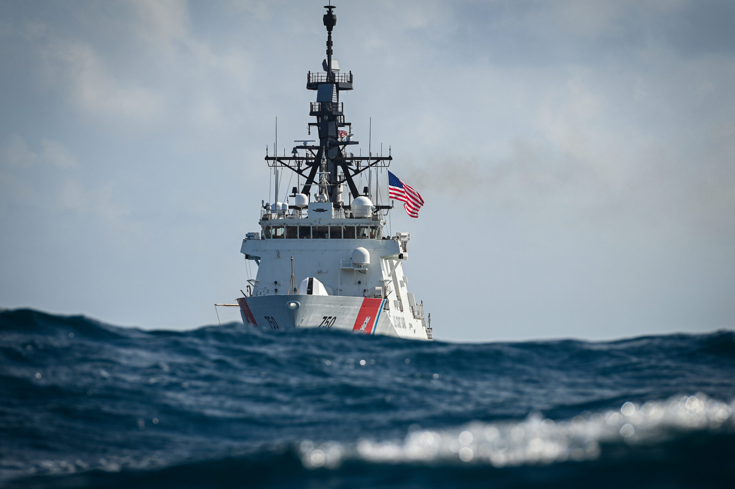 Photo: U.S. Coast Guard Cutter Bertholf with waves in foreground.