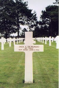 The white gravestone of Jack A. DeNunzio standing among many others.