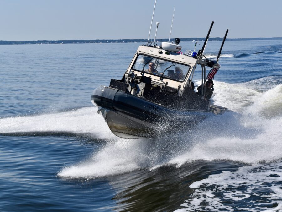 Photo: A PSU boat speeds through the waves