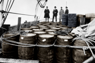 Photograph of about 50 large barrels of alcohol seized by the Coast Guard Cutter Seneca, 1922. The U.S. Coast Guard saw an unprecedented budget boost which allowed to keep the rumrunners at bay.