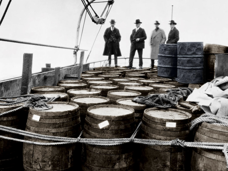 Photograph of about 50 large barrels of alcohol seized by the Coast Guard Cutter Seneca, 1922. The U.S. Coast Guard saw an unprecedented budget boost which allowed to keep the rumrunners at bay.