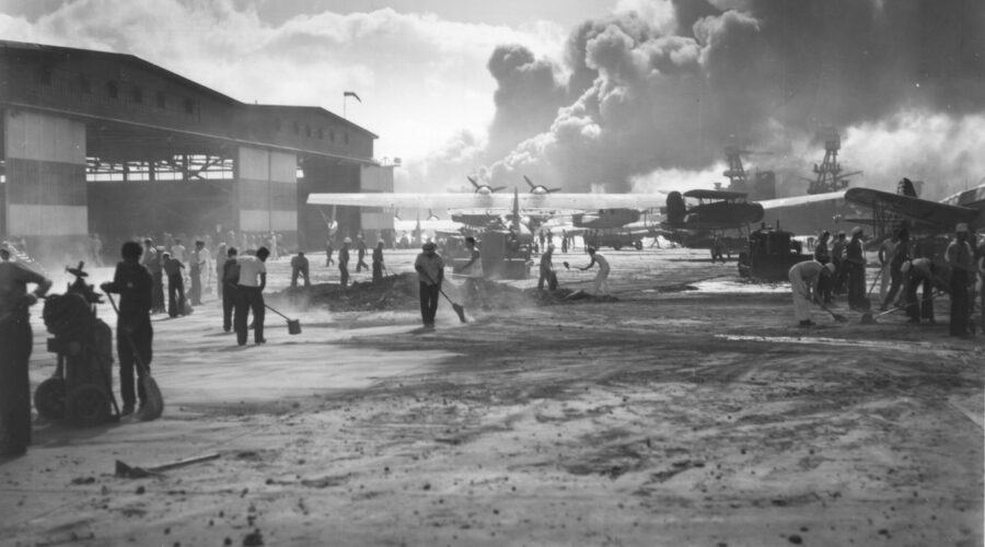 Photo: Service members cleanup damage outside hangars at NAS Pearl Harbor following the attack.